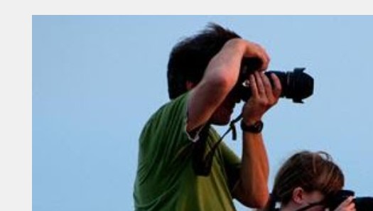 Father and daughter photographing an event