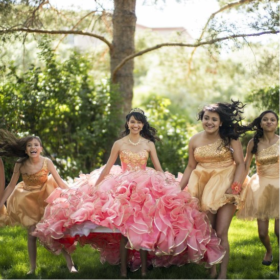 Quinceañera celebrating outdoors with friends