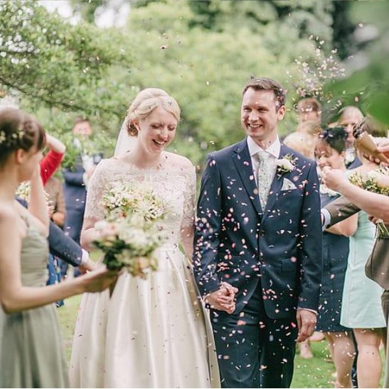 Newly married couple celebrating with guests